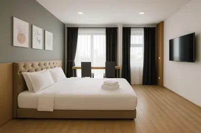 a bedroom with a bed and a table and a television at 3BR max 9pax near MRT Ratchada Good for group in Bangkok