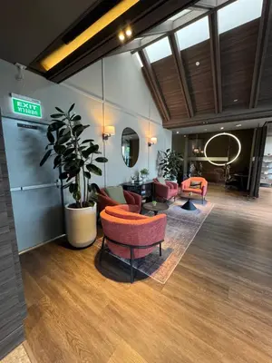 a living room with couches and a plant at Luxury 1 BR Bangkok New CBD High Fl MRT Rama 9 in Bangkok