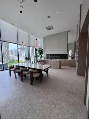a large room with a table and benches in a building at Luxury 1 BR Bangkok New CBD High Fl MRT Rama 9 in Bangkok