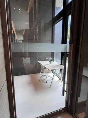 a table and a chair in front of a glass door at Luxury 1 BR Bangkok New CBD High Fl MRT Rama 9 in Bangkok