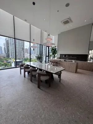a large room with a table and chairs and windows at Luxury 1 BR Bangkok New CBD High Fl MRT Rama 9 in Bangkok