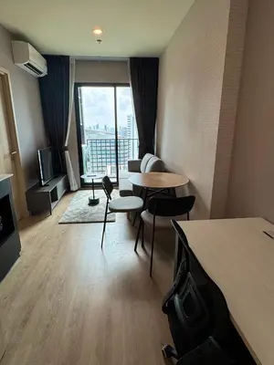 a hotel room with a table and chairs and a large window at Luxury 1 BR Bangkok New CBD High Fl MRT Rama 9 in Bangkok