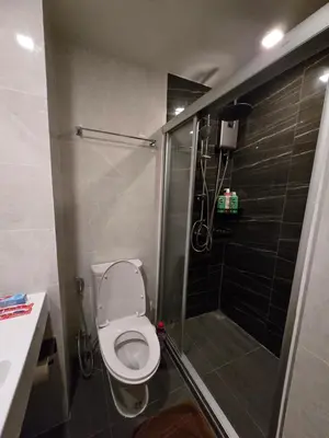 a small bathroom with a toilet and a shower at Fully equipped Ideo Rama9-Asoke, with workstation in Bangkok