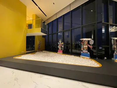 a room with two figurines on a stage in front of a building at Fully equipped Ideo Rama9-Asoke, with workstation in Bangkok