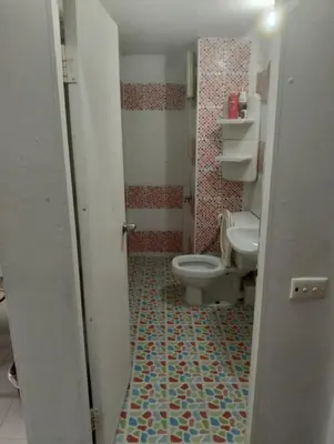 a bathroom with a toilet and a sink at แม่น้องรับตังค์ in Thung Si Kan