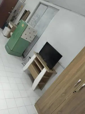 a television sitting on a table in a kitchen at แม่น้องรับตังค์ in Thung Si Kan