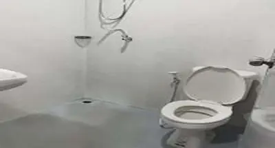 a white bathroom with a toilet and a sink at XX GO INN Khaosan Road BKK - โก อินน์ ถนนข้าวสาร กรุงเทพ in Bangkok