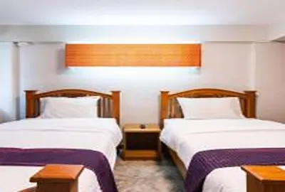 a hotel room with two beds and a window at XX GO INN Khaosan Road BKK - โก อินน์ ถนนข้าวสาร กรุงเทพ in Bangkok