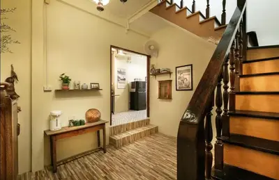 a hallway with a staircase with a mirror at Whole House - 4Bedrooms - Experience Local Life in Bangkok