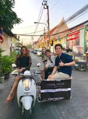 a group of people riding a scooter with a trailer at Whole House - 4Bedrooms - Experience Local Life in Bangkok