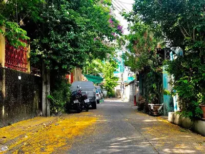 an empty street with a yellow line on the road at Whole House - 4Bedrooms - Experience Local Life in Bangkok