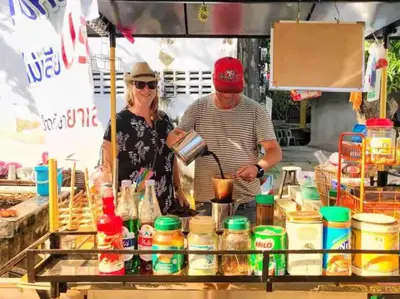 a man and woman preparing food at a food stand at Whole House - 4Bedrooms - Experience Local Life in Bangkok