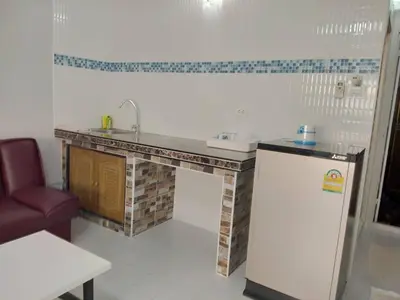 a kitchen with a sink and a refrigerator at Muangthongthani Rental/Khun Dan in Nonthaburi