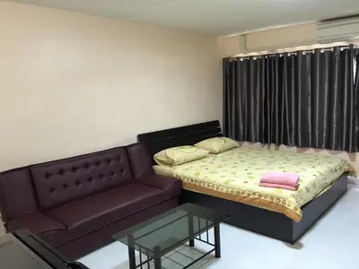 a small bedroom with a bed and a couch at Muangthongthani Rental/Khun Dan in Nonthaburi