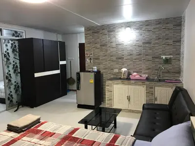 a living room with a refrigerator and a kitchen at Muangthongthani Rental/Khun Dan in Nonthaburi