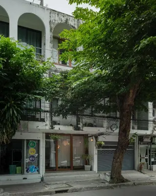 a building with a tree in front of it at Urban Nest Townhouse, Local-feel, Roof,Nightmarket in Bangkok