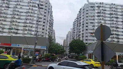 a busy city street with cars and buildings at Popular Muang Thong Condo,Building 5 in Thung Si Kan