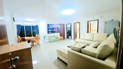 a living room with a couch and a dining room at River View 9 in Bangkok