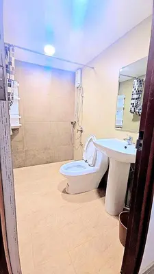 a bathroom with a toilet and a sink at River View 9 in Bangkok