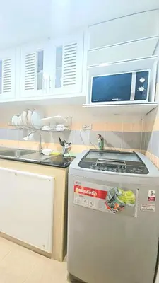 a kitchen with a stove and a microwave at River View 9 in Bangkok