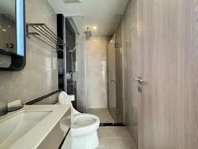 a bathroom with a toilet and a sink and a tub at The Prestige Suites Rama 9 in Bangkok