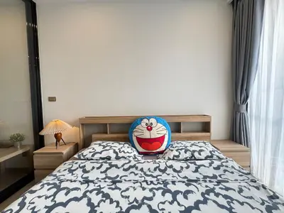 a bedroom with a bed with a pillow on it at The Prestige Suites Rama 9 in Bangkok