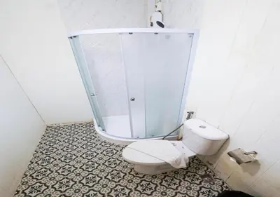 a bathroom with a toilet and a shower at RQ Timeless Dinsor Cultural Heritage House in Bangkok