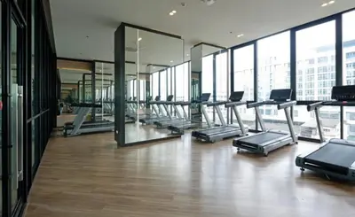 a gym with a row of cardio machines in a building at High Floor Luxury Studio with Great Views in Sathani Ban Hua Mak