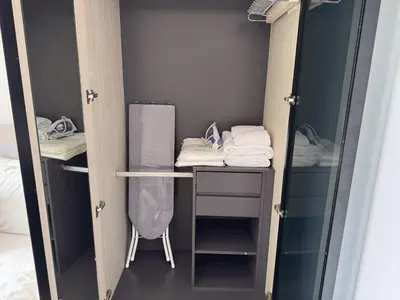 a room with a closet with a desk and towels at High Floor Luxury Studio with Great Views in Sathani Ban Hua Mak