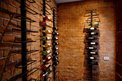 a wall of wine bottles on a brick wall at Luxury Pure Modern Pool Villa 5Bed KTV Gym Nr BTS&Central in Bangkok
