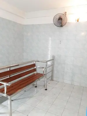 a bench in a room with a tiled wall at New Central Guesthouse in Bangkok