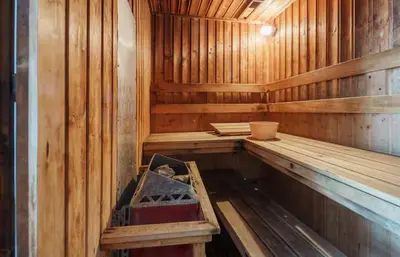 an empty wooden sauna with a bench in it at Spacious 2 King Beds, Balcony with View, Near Nana BTS in Bangkok