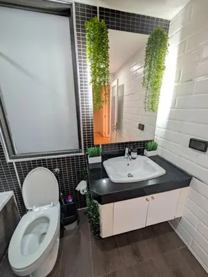 a bathroom with a toilet and a sink and a mirror at Spacious 2 King Beds, Balcony with View, Near Nana BTS in Bangkok