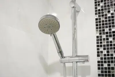 a shower with a shower head in a bathroom at Amazing Pool and Luxury Condo Unit Near Phrom Phong BTS in Bangkok