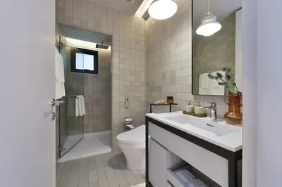 a bathroom with a sink and a toilet and a shower at Tree Villa Bangkok in Bangkok