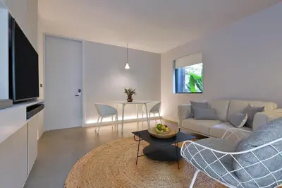 a living room with a couch and a table at Tree Villa Bangkok in Bangkok