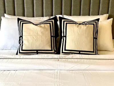 a bed with four pillows on top of it at Vibrant City Retreat 6 Mins Walk BTS Nana, 1BR in Bangkok