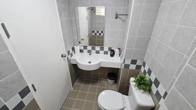 a bathroom with a toilet and a sink at Easy Living in Bang Khen