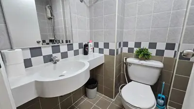 a bathroom with a toilet and a sink at Easy Living in Bang Khen