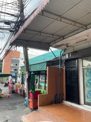a building with awning on the side of a street at GO Inn Rama 3 BKK - โกอินน์ พระราม 3 in Bang Khlo