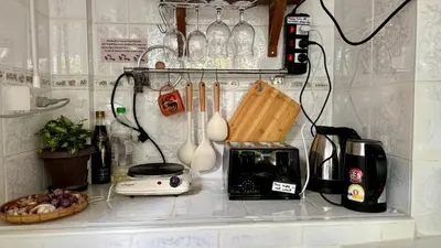 a kitchen counter with a toaster a toaster and a blender at Baan PadSeeEw - Rooftop Riverview 2nd floor in Thonhuri