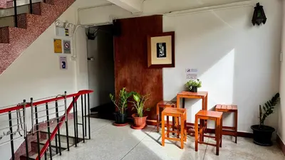 a room with two tables and chairs in a building at Baan PadSeeEw - Rooftop Riverview 2nd floor in Thonhuri