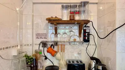 a kitchen with a shelf with many glass jars at Baan PadSeeEw - Rooftop Riverview 3rd floor in Thonhuri