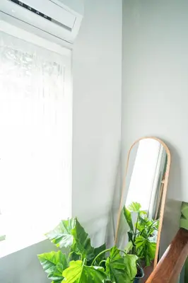 a mirror sitting on a table next to plants at Baan Lek Tee 6 - 9Chinatown near Yaowarat and MRT in Bangkok