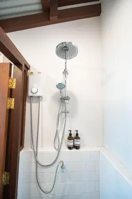 a shower in a bathroom with a shower head at Baan Lek Tee 6 - 9Chinatown near Yaowarat and MRT in Bangkok