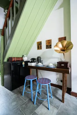 a kitchen with a wooden table and two stools at Baan Lek Tee 6 - 9Chinatown near Yaowarat and MRT in Bangkok