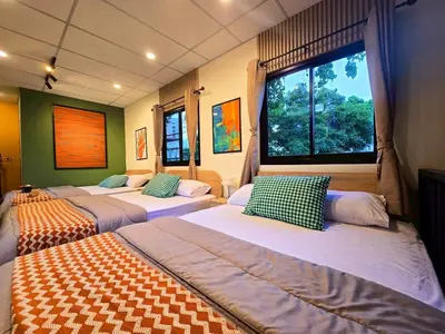 a room with three beds and a large window at Cozy Canal House 1 min to MRT & Street Foods in Bangkok