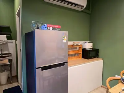 a kitchen with a refrigerator and a counter at Cozy Canal House 1 min to MRT & Street Foods in Bangkok