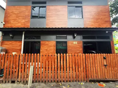 a house with a wooden fence in front of it at Cozy Canal House 1 min to MRT & Street Foods in Bangkok