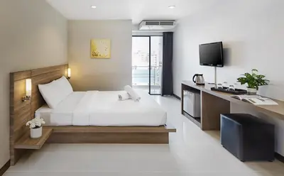 a hotel room with a bed and a television at Diamond Residence Ratchada in Bangkok